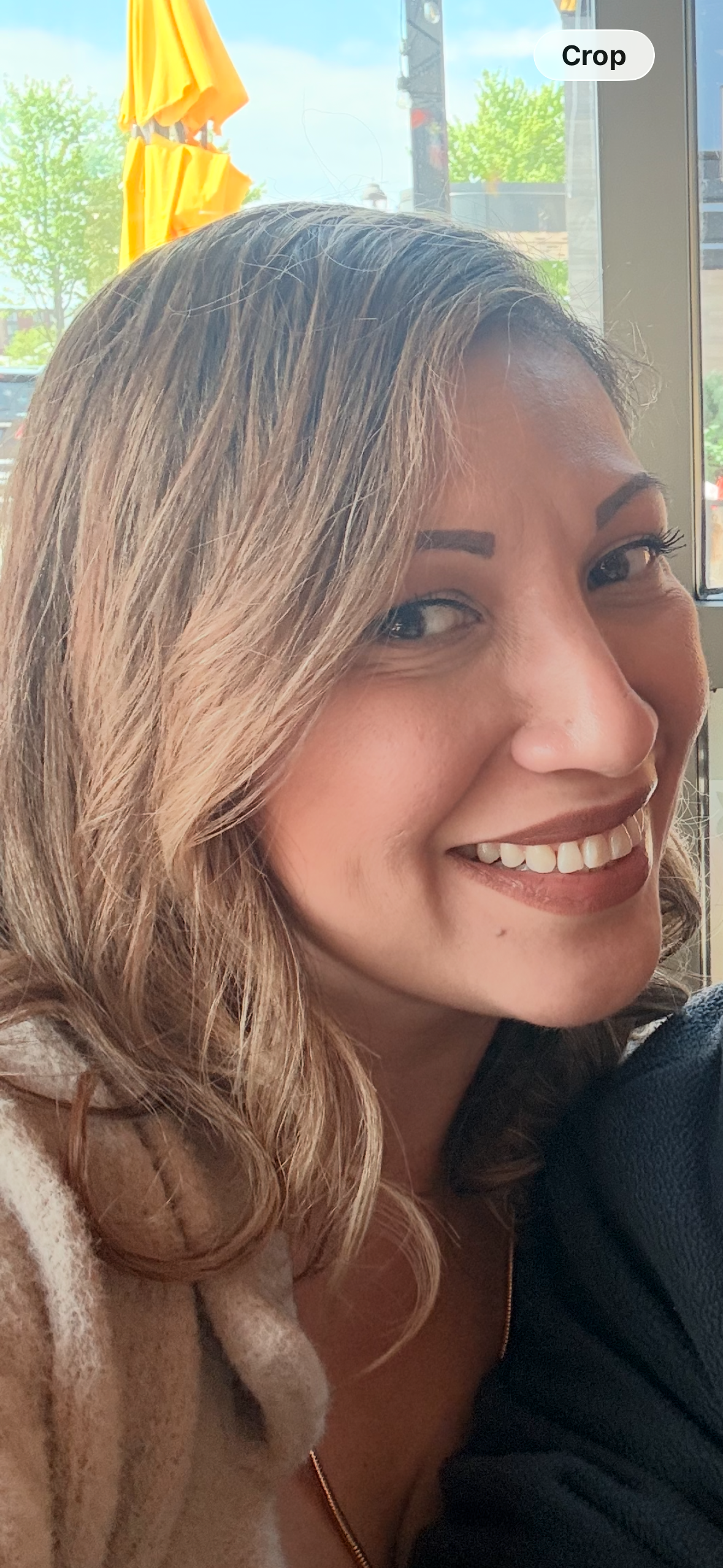 Fabiola Estrada smiling in a bright café